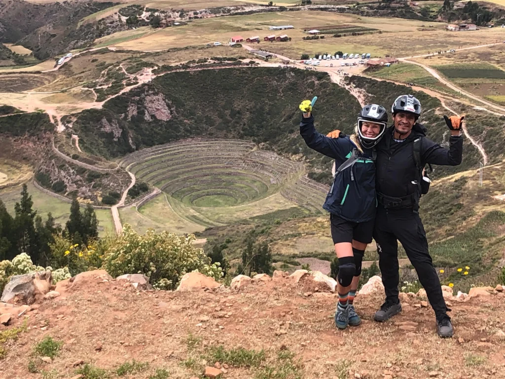 Mountain bikers above the Inca terraces of Moray in the Sacred Valley